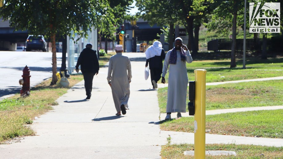 Somali men walking in Cedar–Riverside Minneapolis