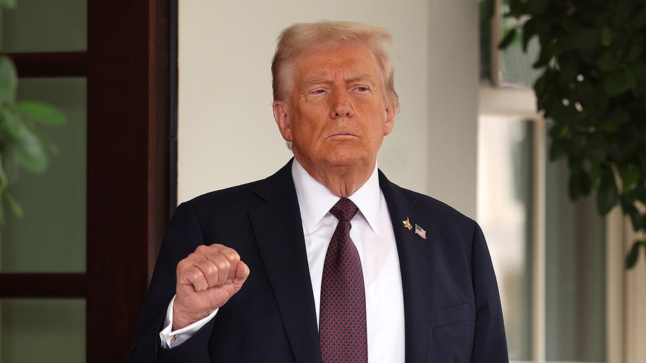 Trump at the White House holding up a fist