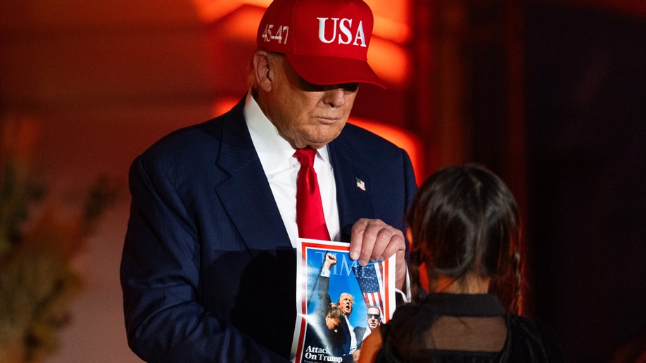 Donald Trump holds Time Magazine cover at White House Halloween celebration