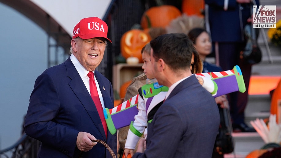 President Donald Trump hands out candy at White House Halloween celebration