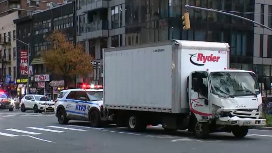 Truck hits parked van in Midtown Manhattan, pushing vehicle onto sidewalk and injuring 9