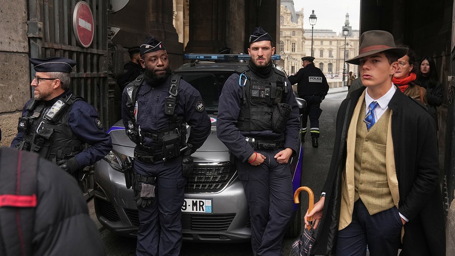 Mystery man in dapper suit goes viral after appearing in Louvre heist investigation photo