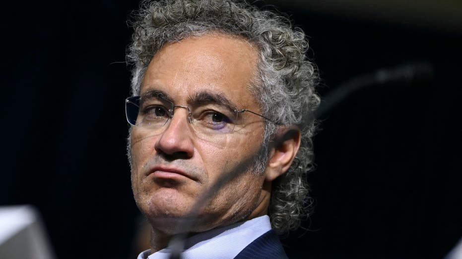 Palantir CEO looks to his left