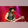 D'Angelo plays the guitar on stage.
