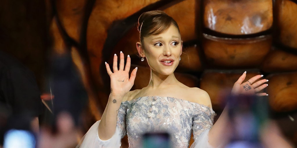 Fan grabs Ariana Grande at 'Wicked: For Good' premiere in