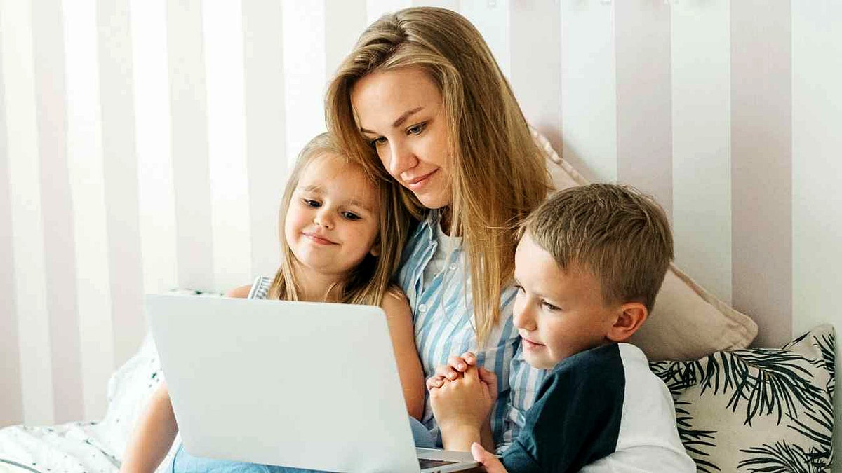 A parent  browses the net  with her children.