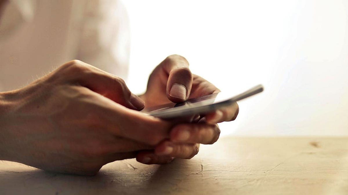 A man holds a smartphone.