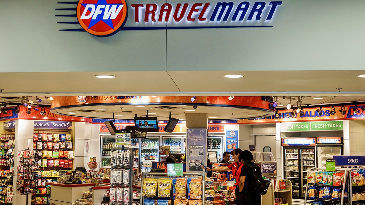 Customer shopping at airport travel mart.