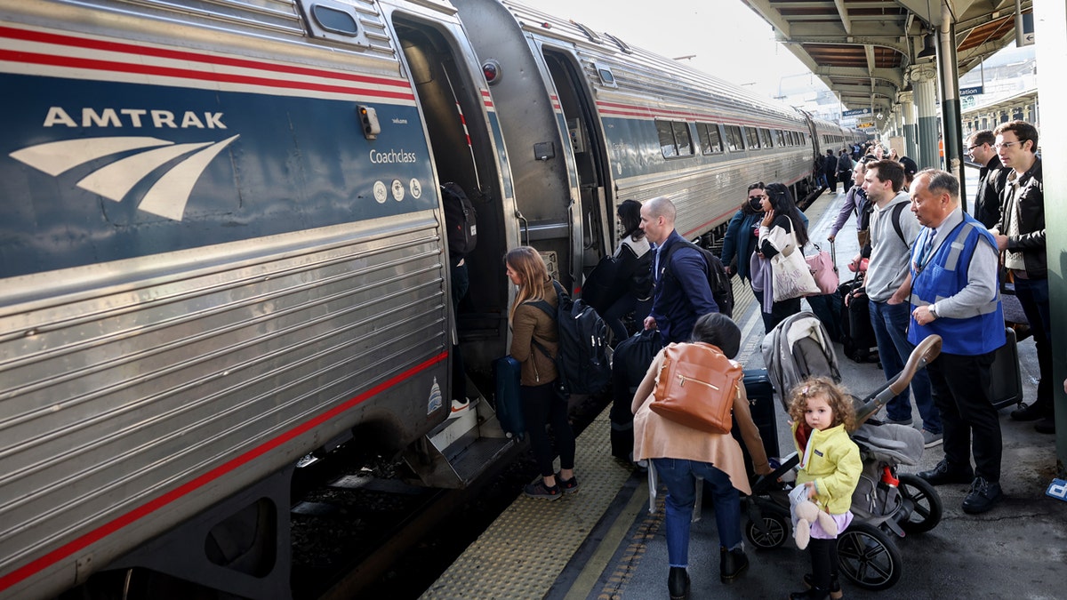 Travelers board an Amtrak train at Union Station on November 22, 2023 in Washington, DC.