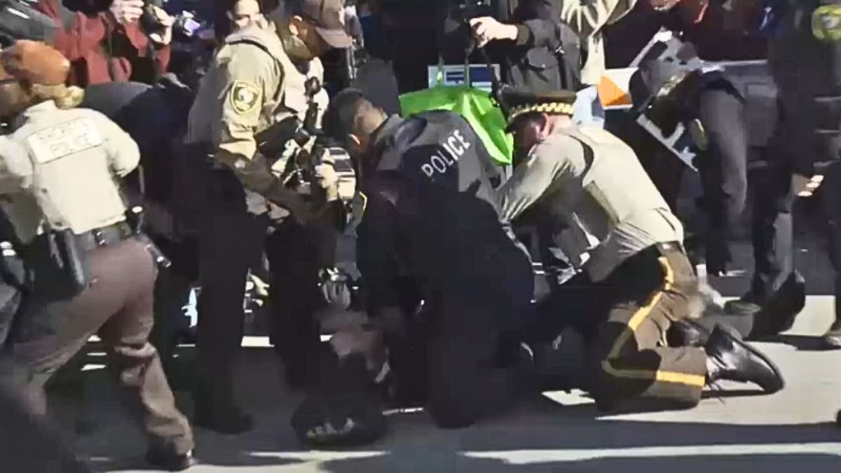Police officers apprehension a protester during an anti-ICE objection successful Chicago.