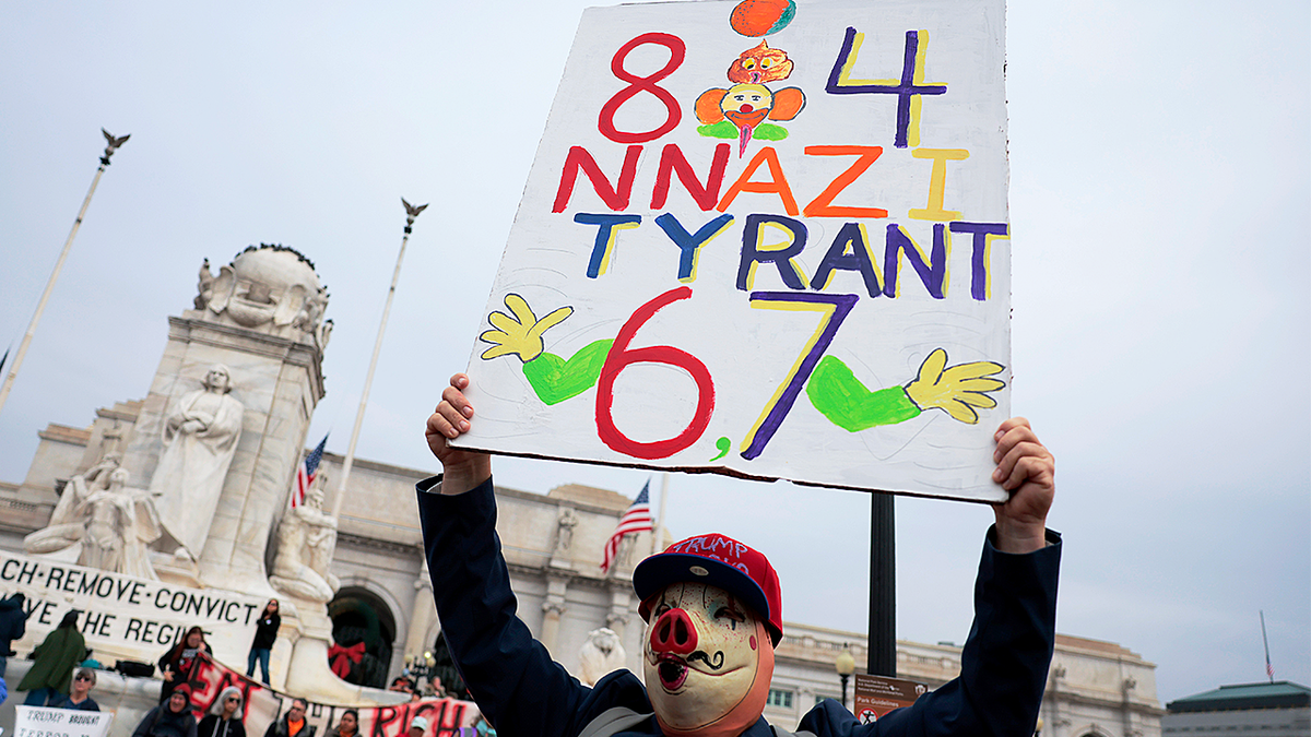 Anti-Trump protester in Washington holds 'Nazi' sign