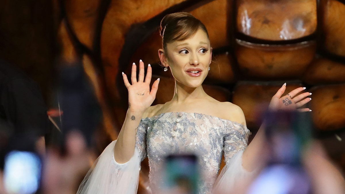Fan grabs Ariana Grande at 'Wicked: For Good' premiere in