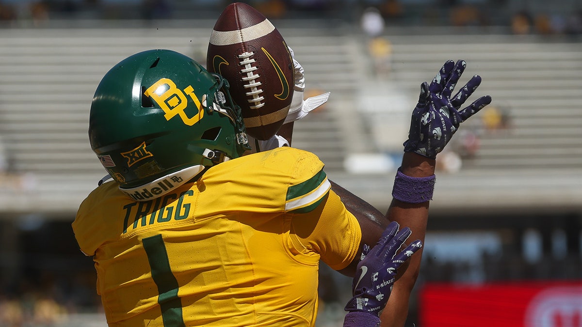 Michael Trigg ties to get a hold on the ball