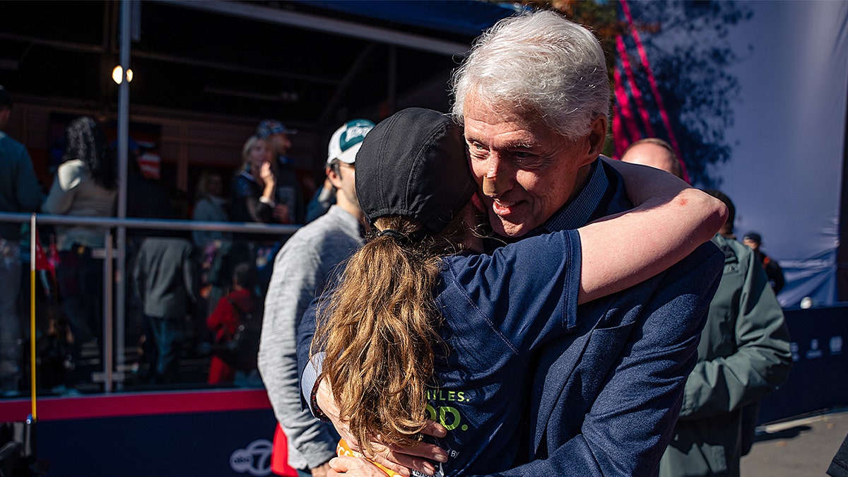 Bill Clinton and Chelsea Clinton hugging in NYC.