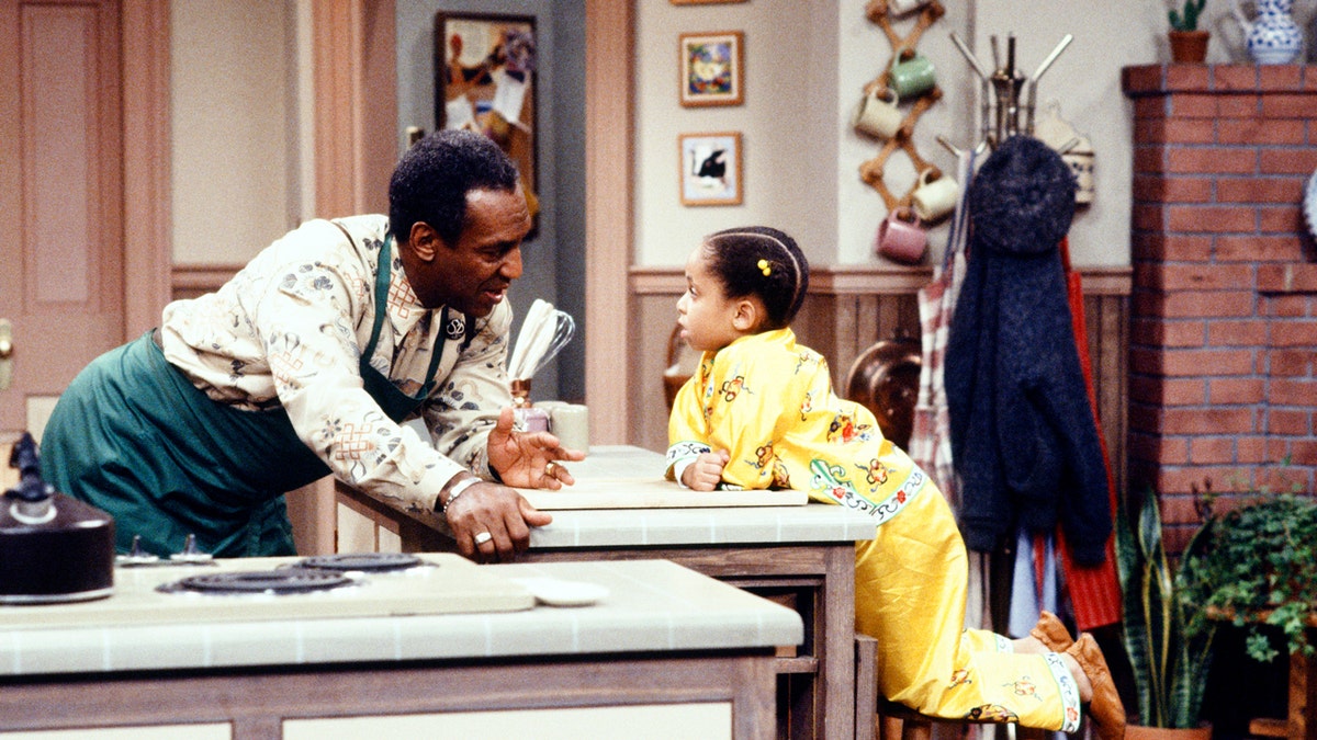 Bill Cosby and Raven Symone in a scene from The Cosby Show
