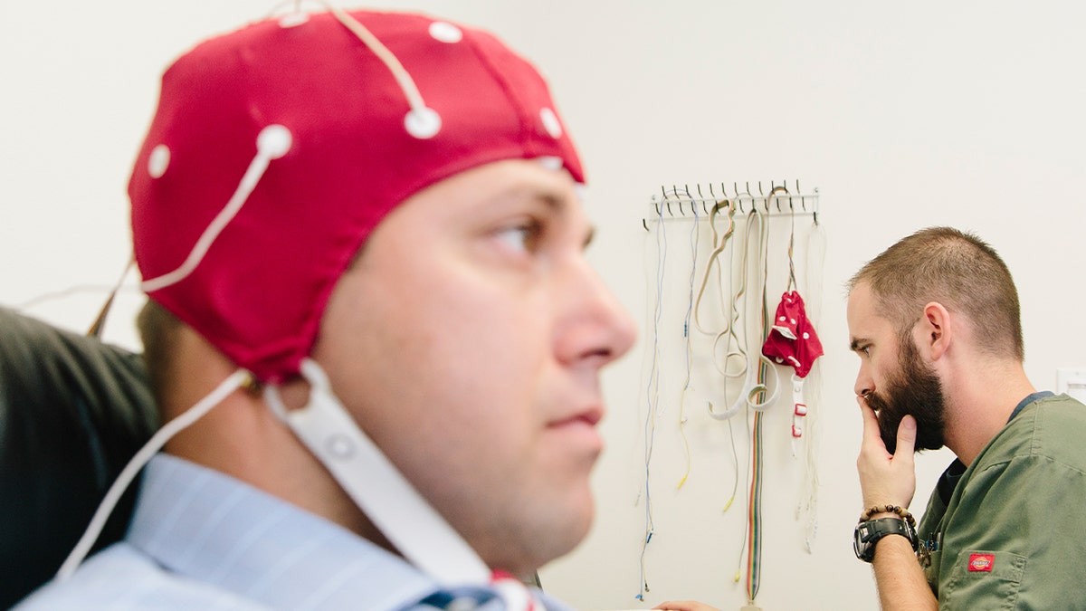 Iraq war veteran Joseph Hummel is administered an electroencephalography (EEG) by fellow veteran Ryan Wood, operations coordinator and technician at Brain Treatment Center.