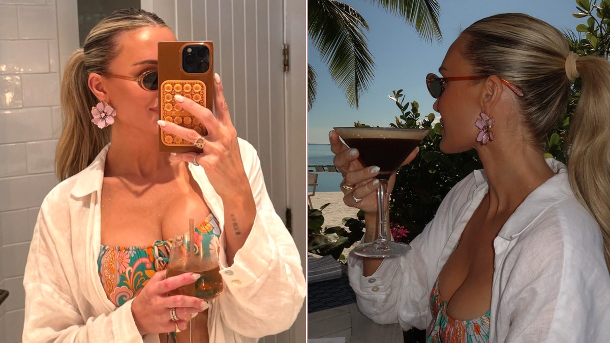 Brittany Aldean wearing a floral-print bikini and flower earrings, taking a mirror selfie and sipping a cocktail during a tropical vacation.