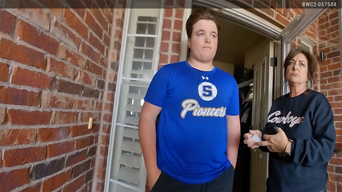 Jesse Butler and his mom listen to police