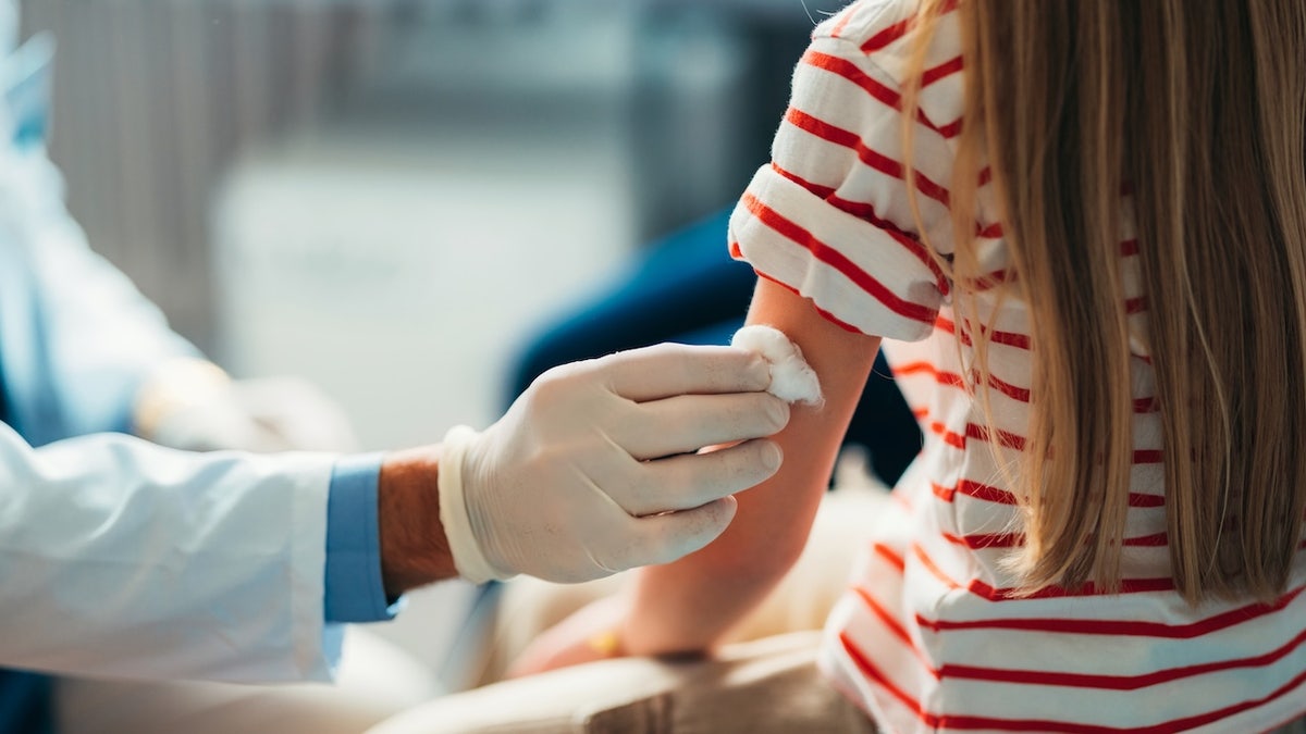 Child prepping for vaccine at doctor's office