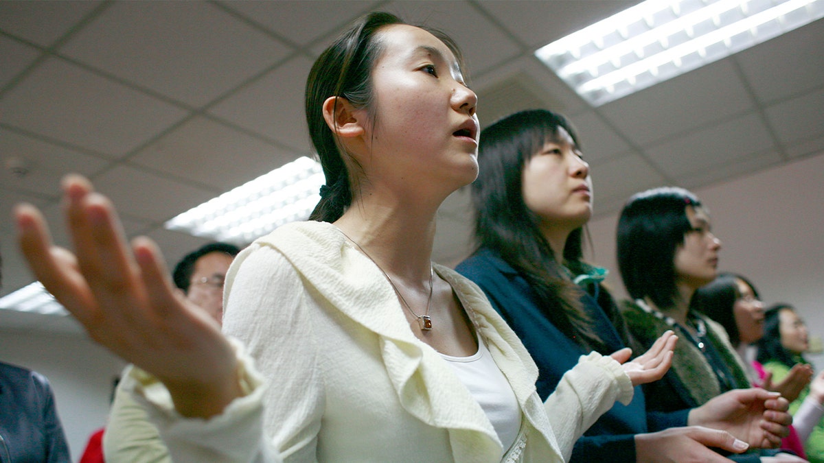 Worshippers gather during a small indoor Christian gathering in Beijing.