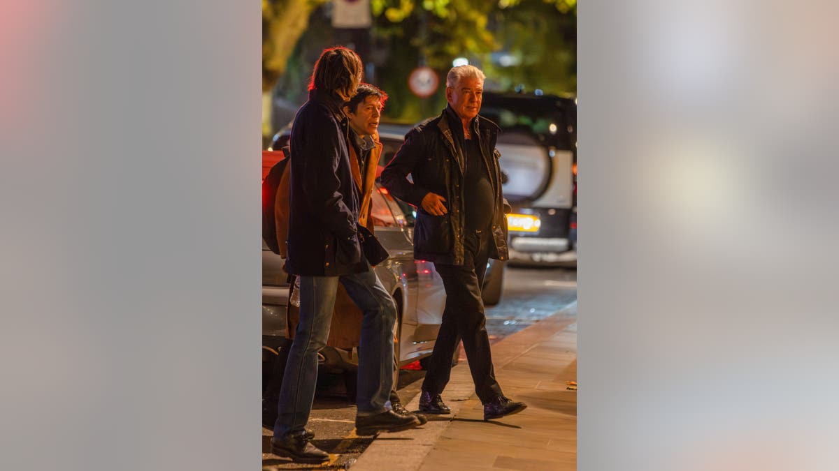 Pierce Brosnan walks on a London street with his sons Christopher and Dylan Brosnan after a family dinner at Dorian restaurant.