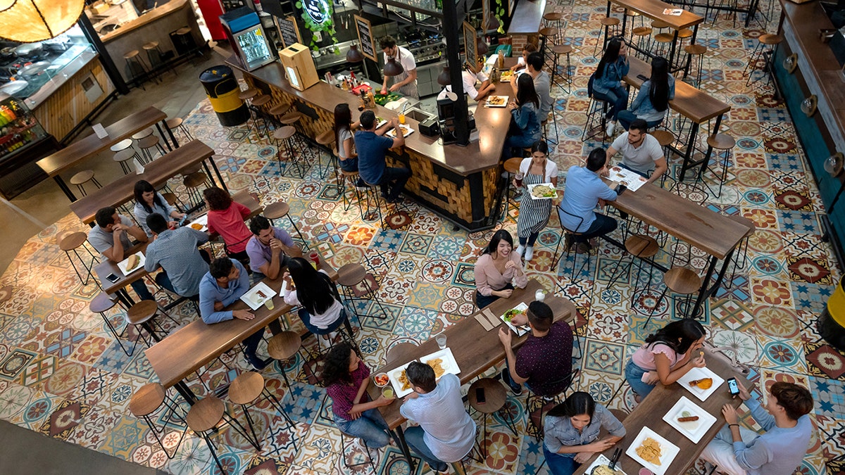 Communal dining makes Gen Z comeback, but older guests push back on 'chaotic' trend  at george magazine