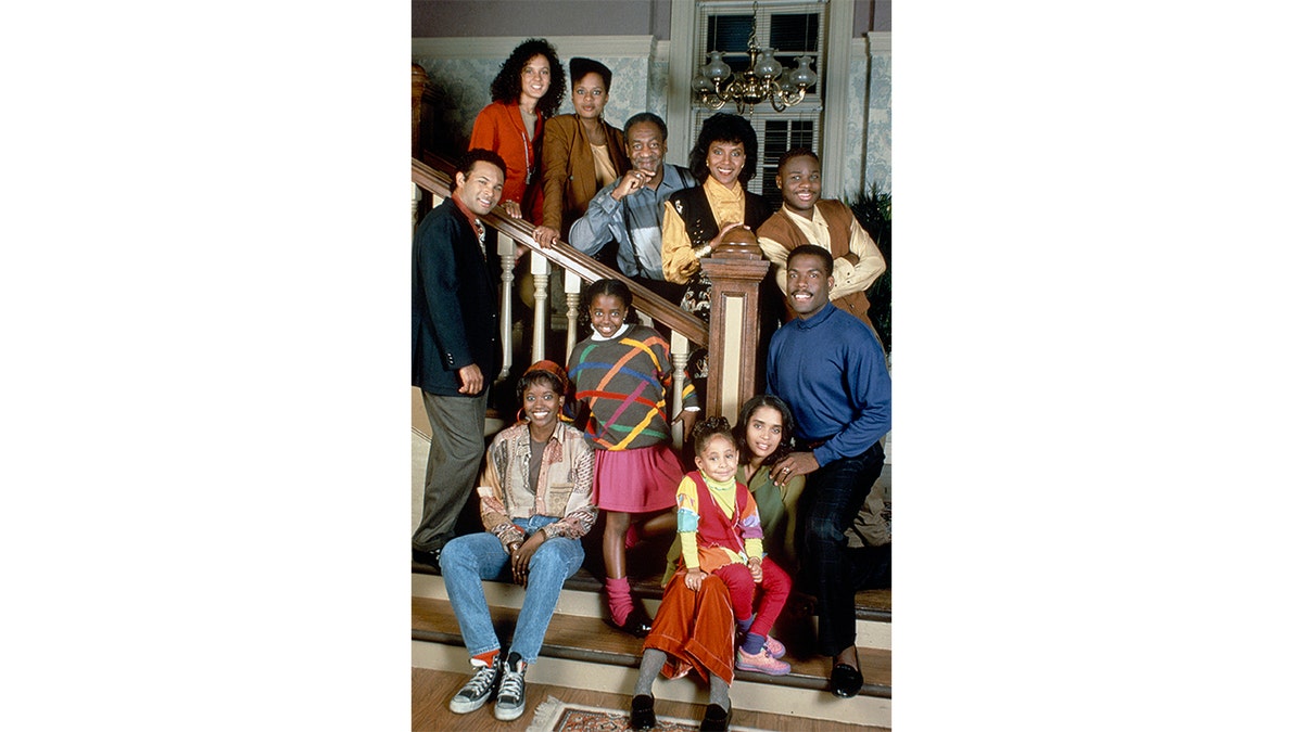 The cast of the cosby show on the stairs