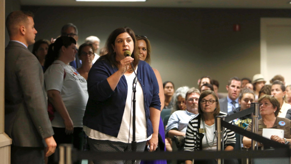 Dana Williamson speaks into a microphone