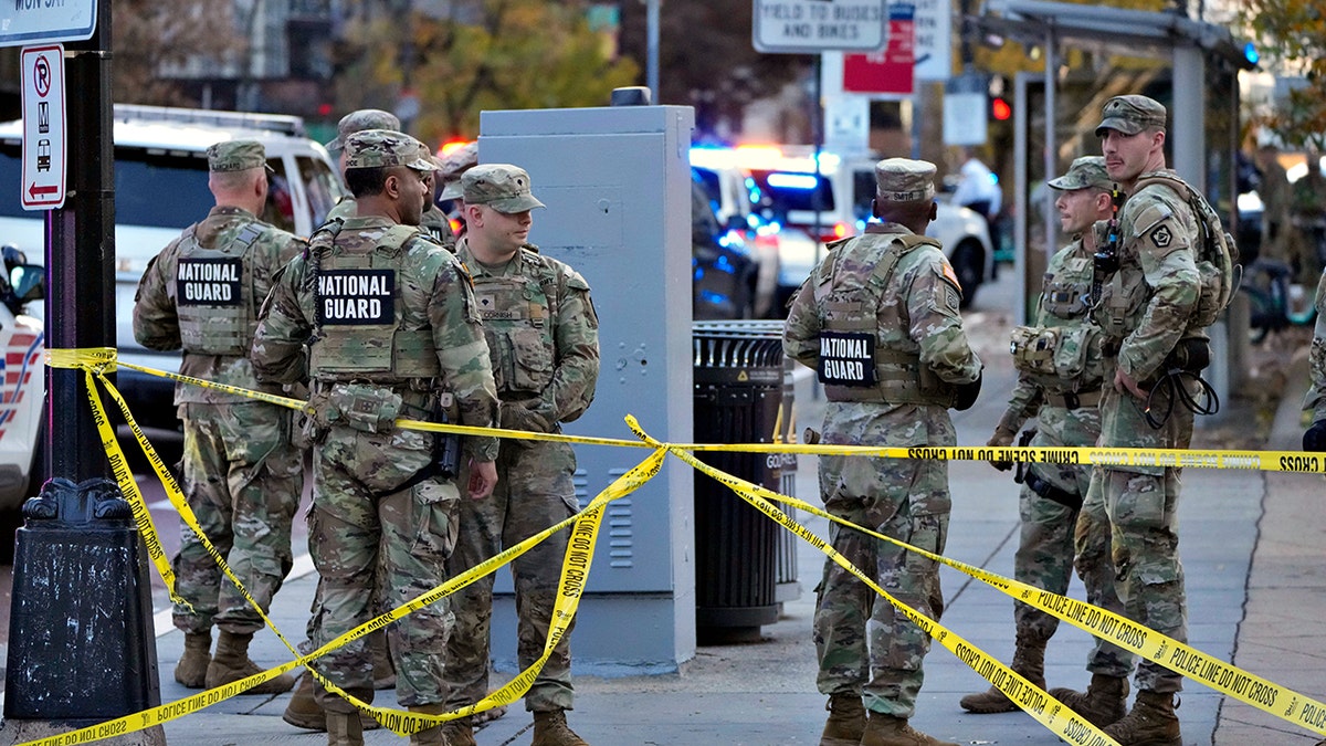 Members of the National Guard gather on sidewalk