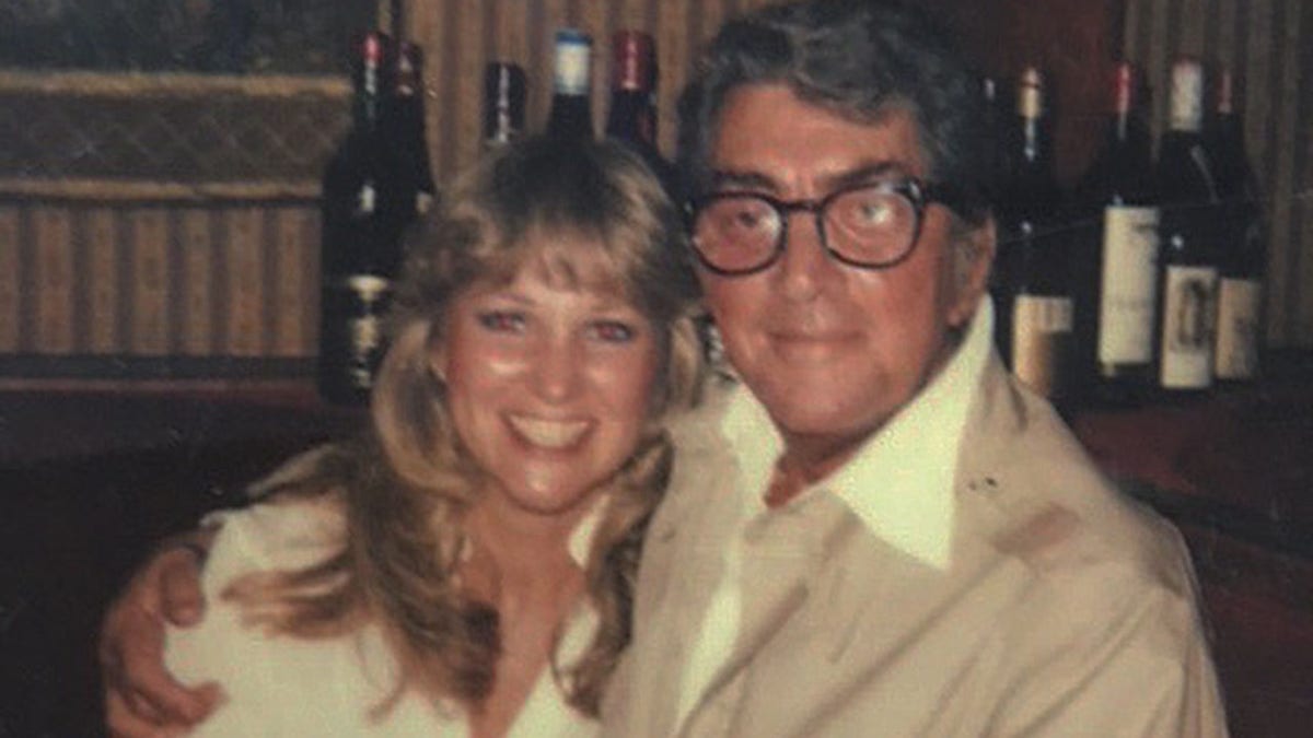 Dean Martin embracing Peggy Crosby