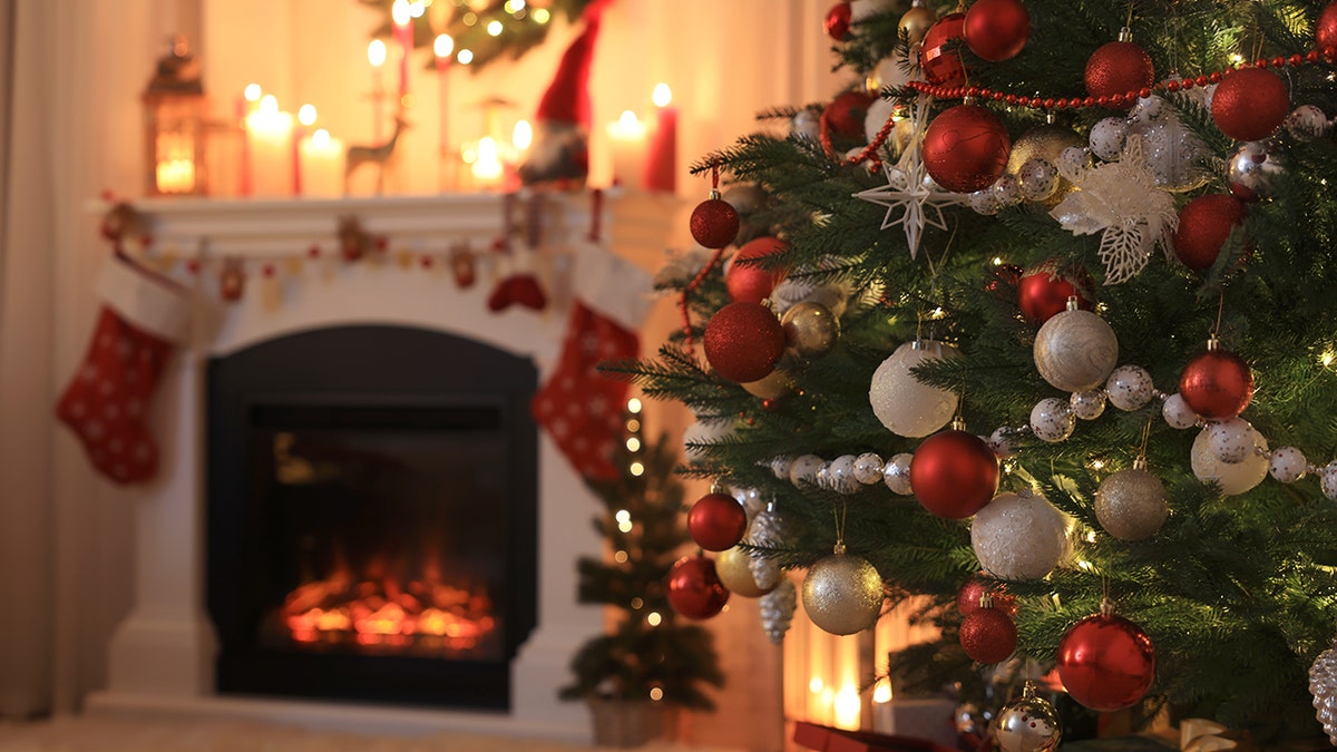 A festive living room with a closeup of the decorations on the Christmas tree.