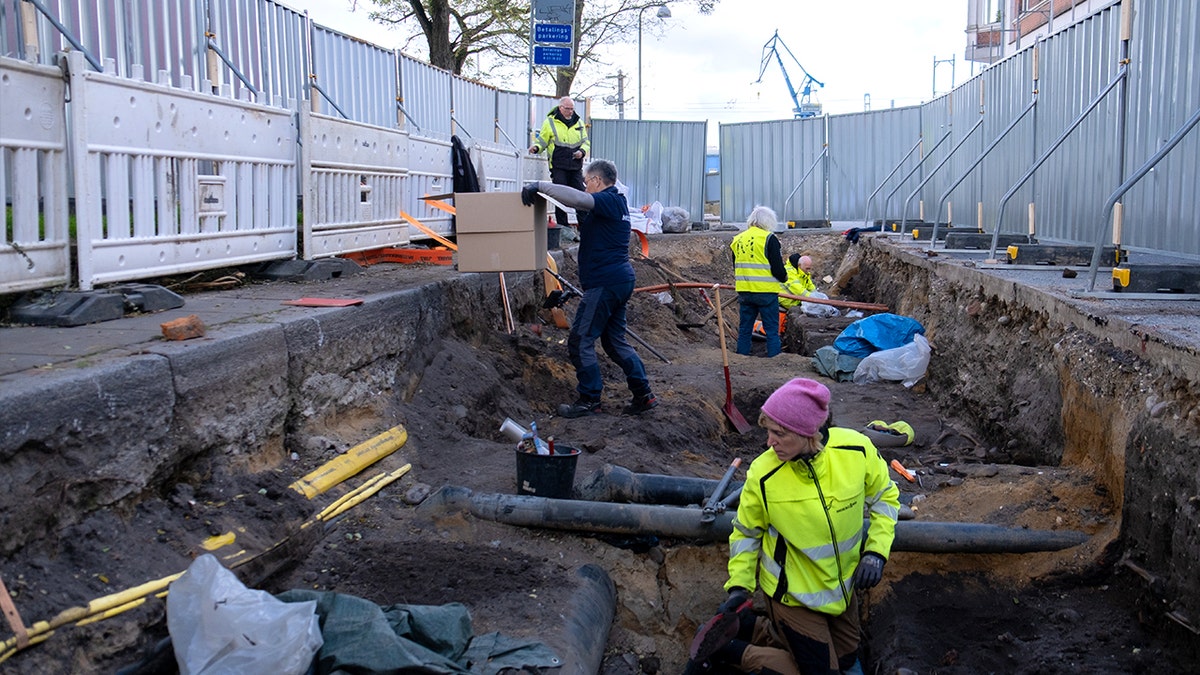 Archaeologists digging at grave site