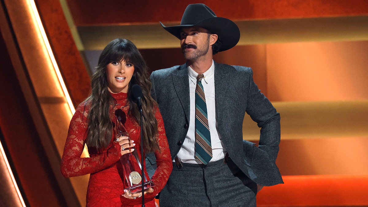 Ella Langley and Riley Green accepting their award.