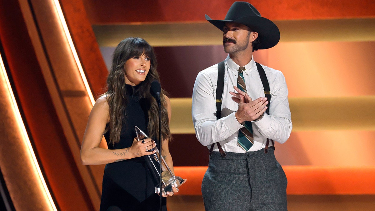 Ella Langley and Riley Green accepting their award at the CMA Awards.