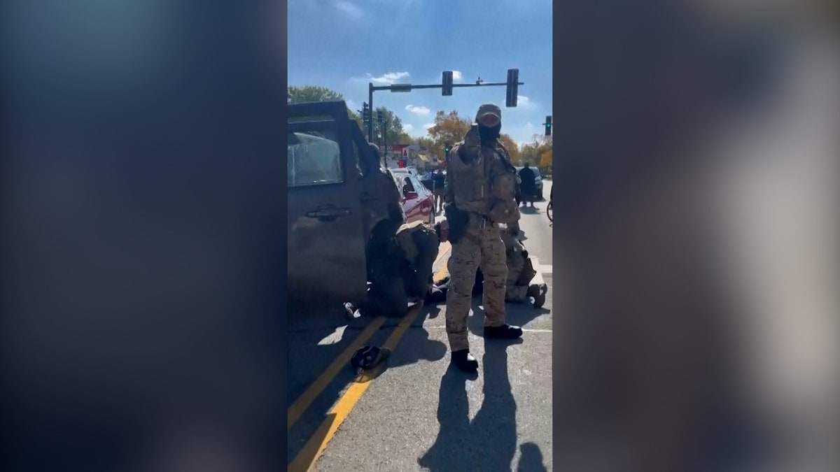 Federal agent pointing a pepper spray.