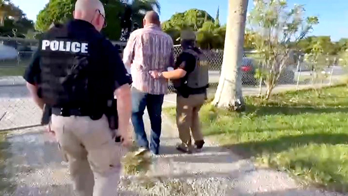 federal officials arresting man