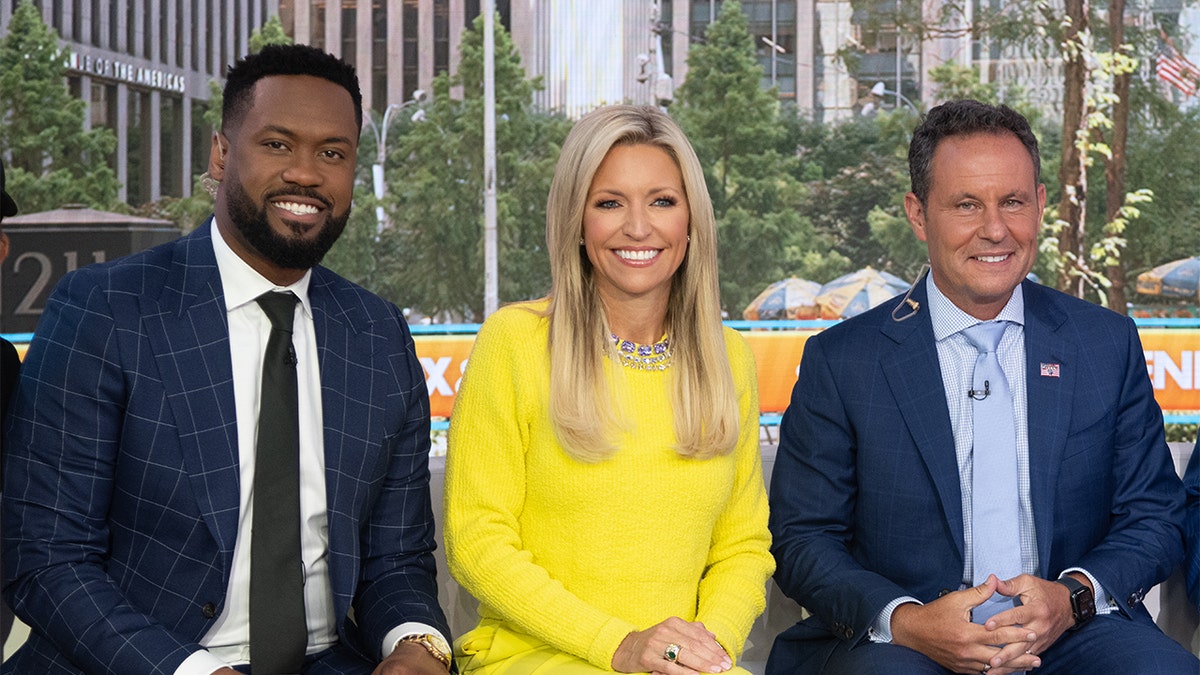 Brian Kilmeade, pictured here sitting next to Lawrence Jones and Ainsley Earhardt on the "Fox &amp; Friends" set on July 21, 2025 in New York City, is the host of the Fox Nation series, "What Makes America Great."