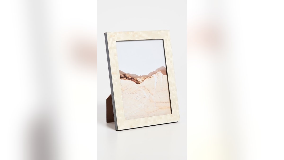 Show off beloved photos with this gold-tone frame.