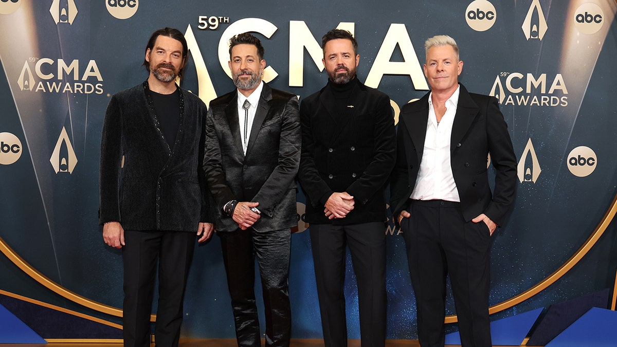 Members of Old Dominion — Geoff Sprung, Matthew Ramsey, Brad Tursi and Trevor Rosen — pose together on the red carpet wearing black suits at the 59th Annual CMA Awards in Nashville, Tennessee, on November 19, 2025.