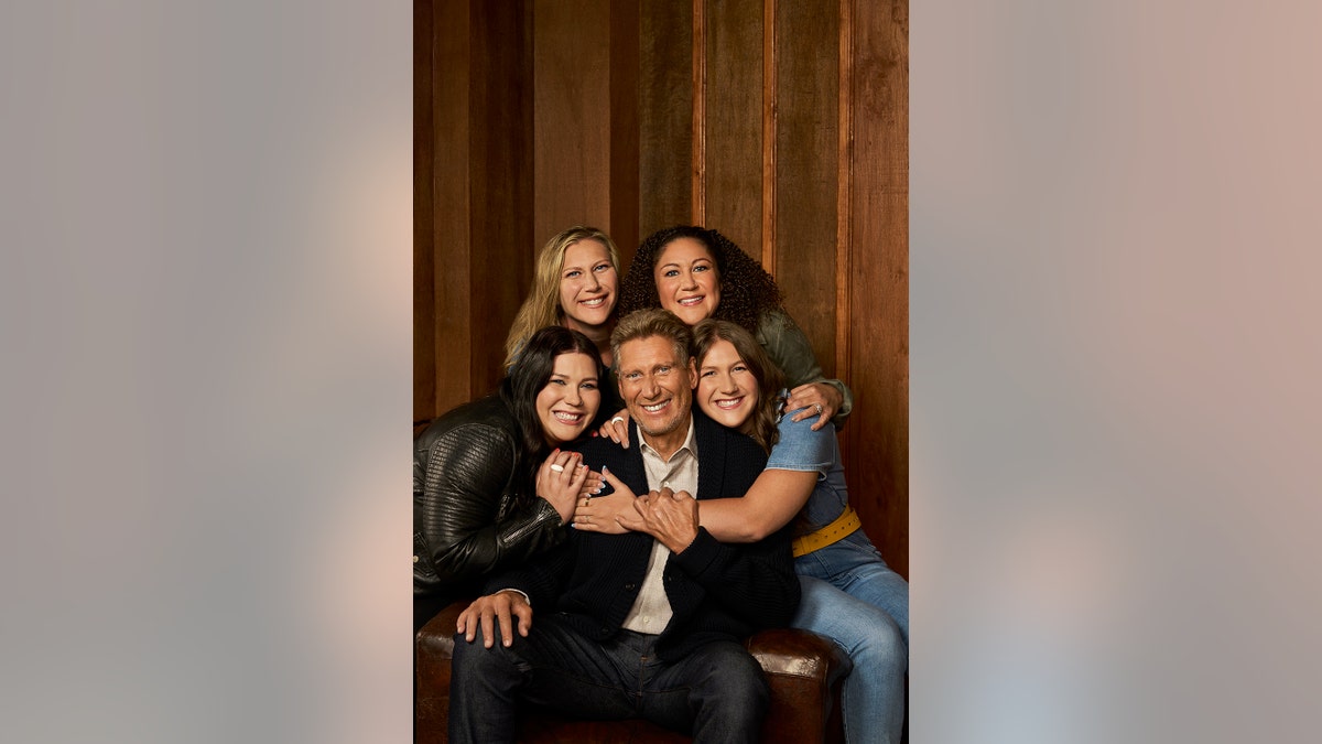 Gerry Turner being embraced by his daughters and granddaughters.