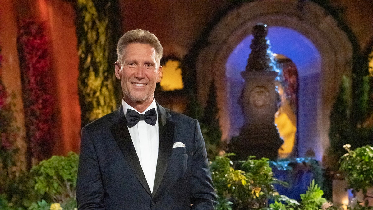 Gerry Turner wearing a tux and smiling inside a glamorous venue.