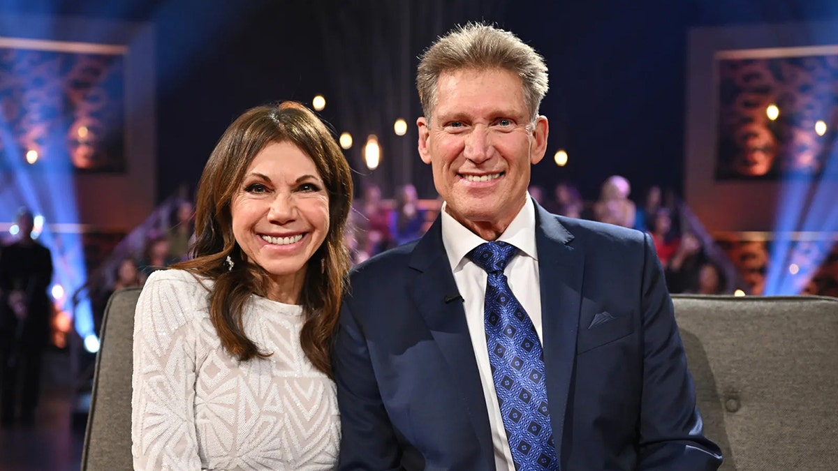 Theresa Nist wearing a white sweater and Gerry Turner wearing a dark blue tux with a matching tie.