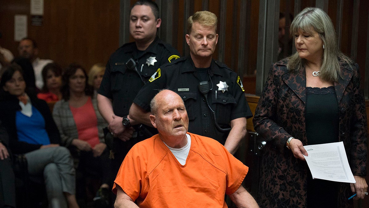 The Golden State Killer in court surrounded by officers.