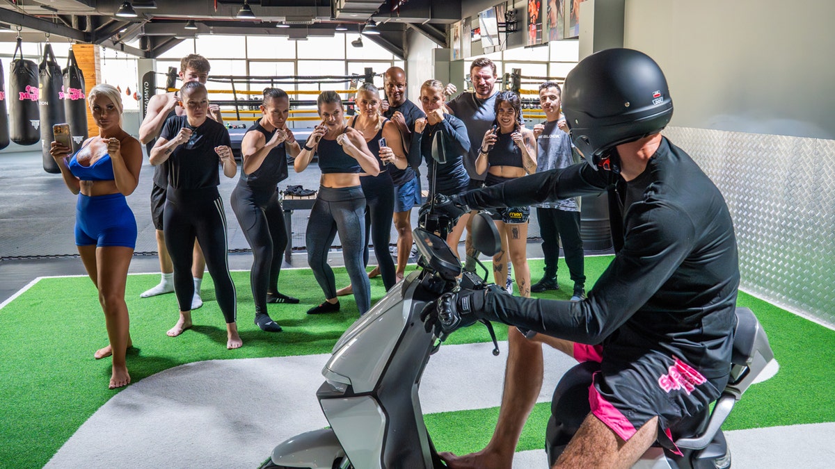 people working out gym nation and man on bike