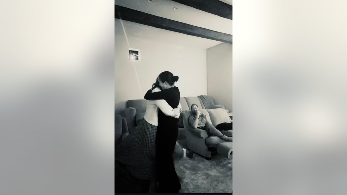 The friends are pictured hugging after the victory. 