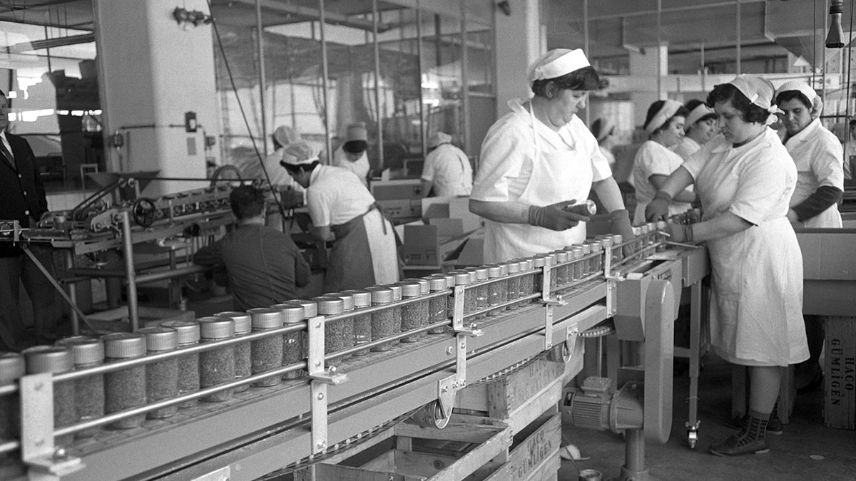 Factory line workers in 1950s making instant coffee