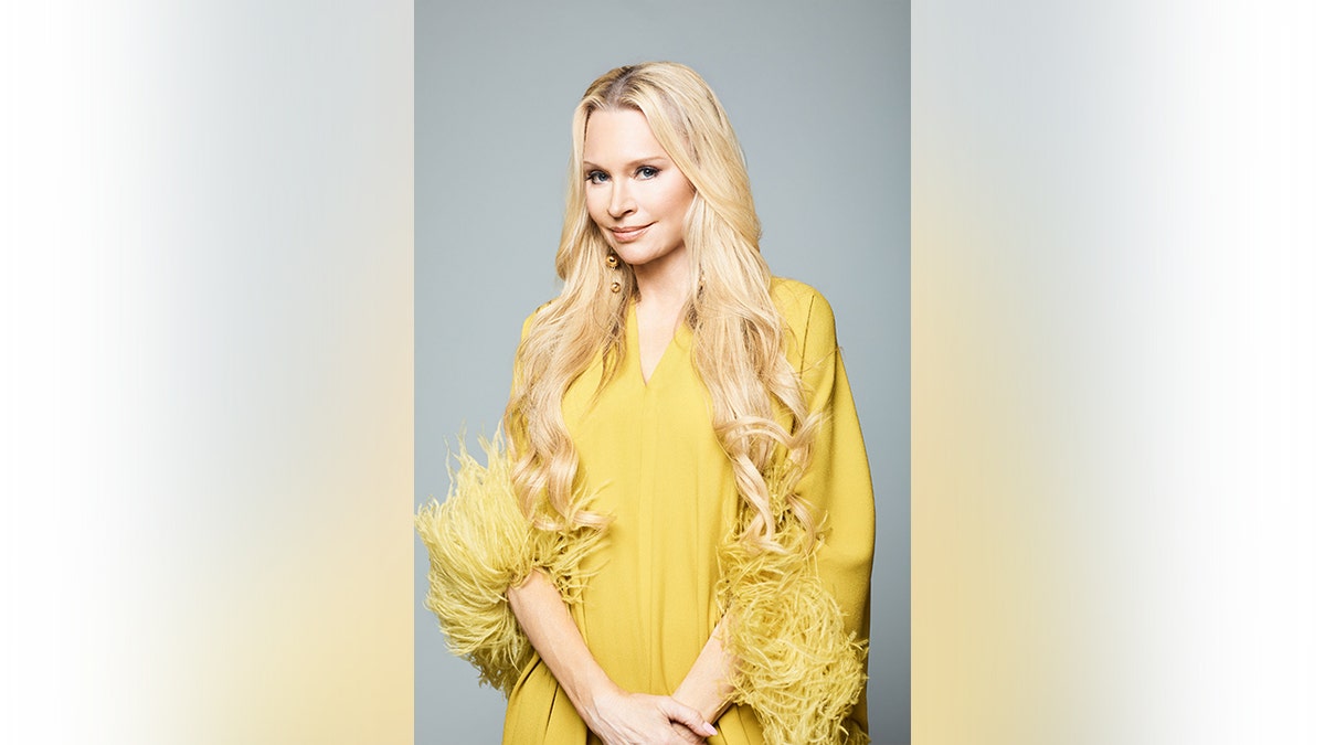 Jackie Siegel wearing a yellow feathered top