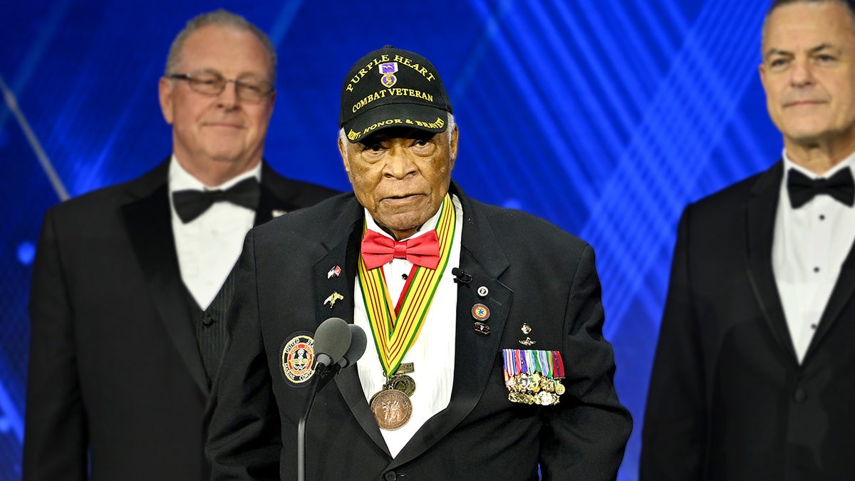 Major James Capers Jr. stands on stage while accepting the 'Salute to Service Award' at the 2025 Fox Nation Patriot Awards.