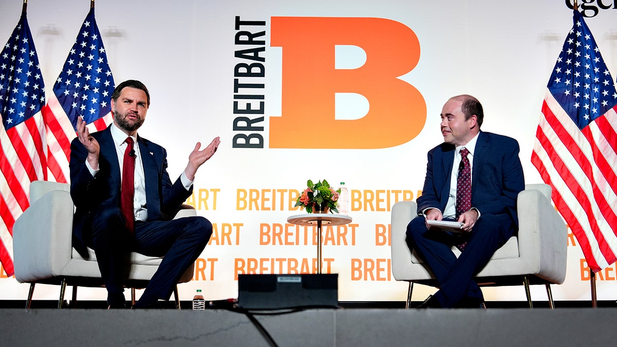 Vice President JD Vance gestures while answering a question on stage