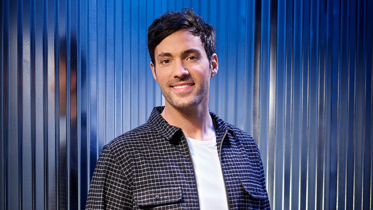 Jeff Dye smiles against a blue background